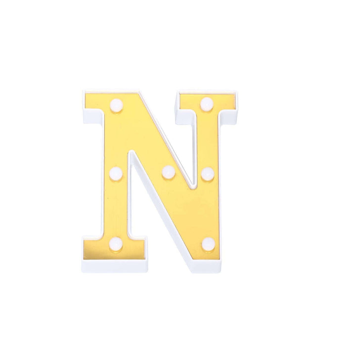 Gold marquee letter "N" on a white background.