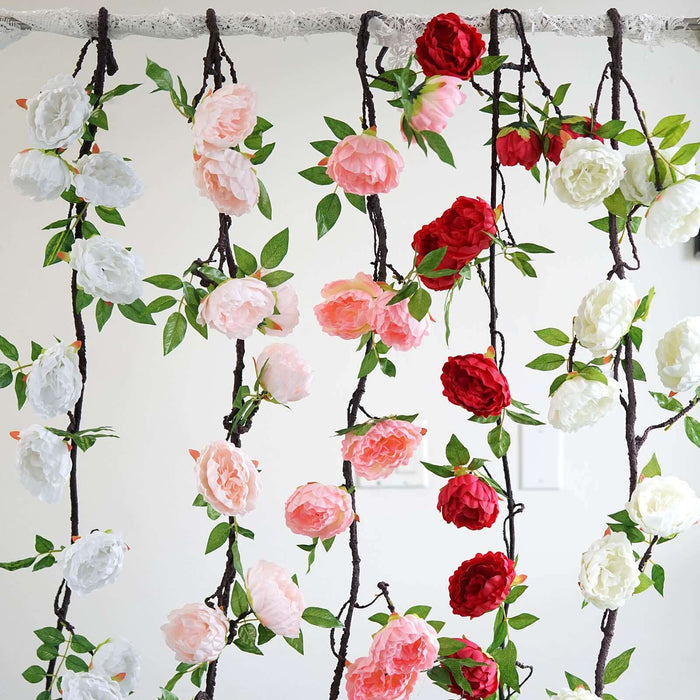 Colorful artificial flower garland with red, pink, and white blooms.