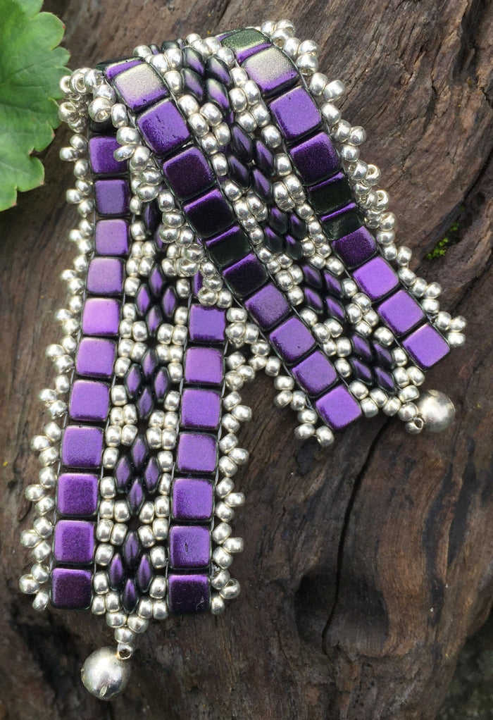 This bead woven bracelet combines velvety Dark Purple Czech Glass tiles with Silver glass seed beads and measures 6 5/8".