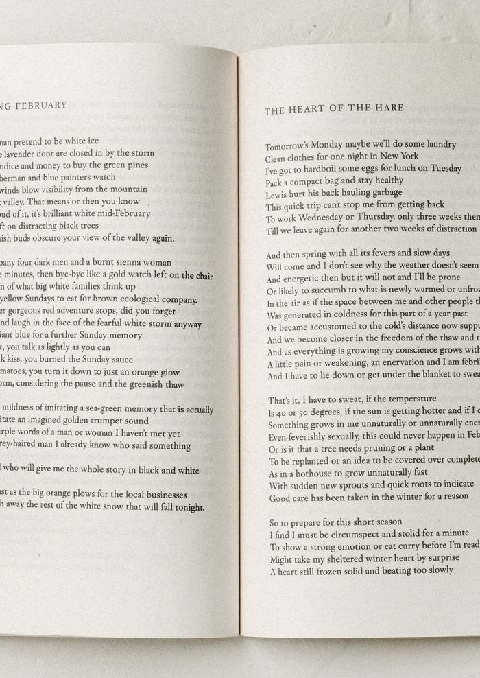 An open book with poems in black text.