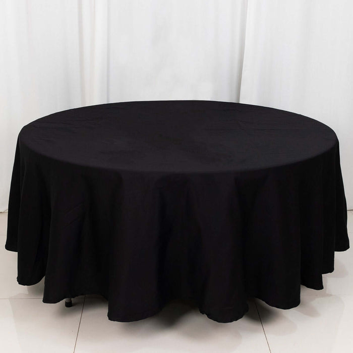 Black round tablecloth with elegant draping, perfect for events and dining.
