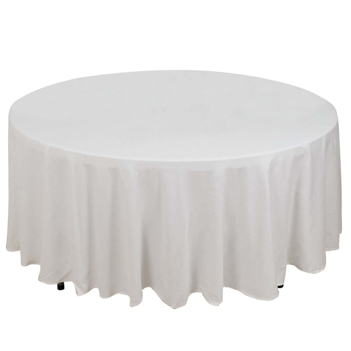 Round table with a white tablecloth, elegantly draped.