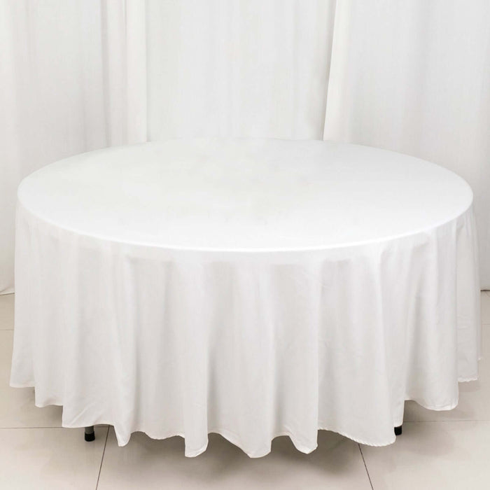 Round white tablecloth draped over a circular table