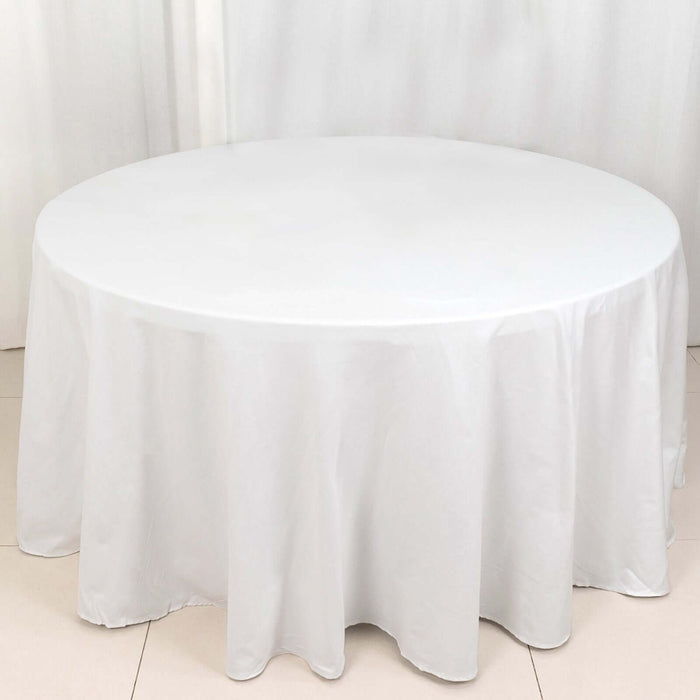 Round white tablecloth draped over a circular table.