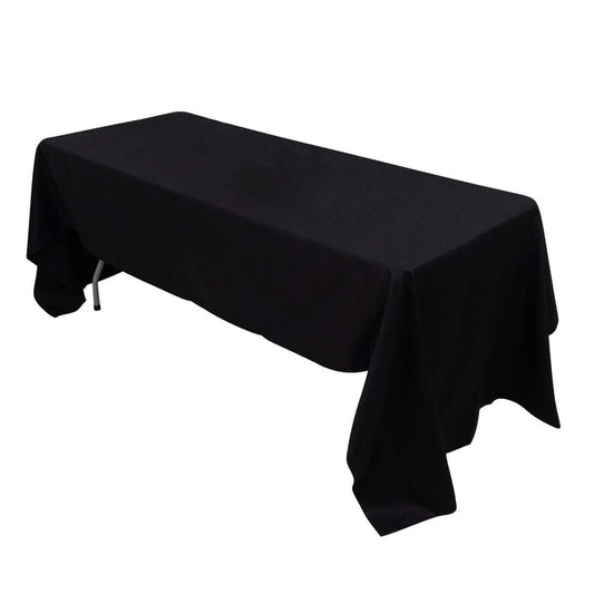 Black tablecloth draped over a rectangular table in studio isolation.