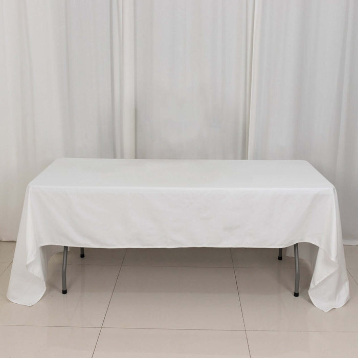 White table covered with a tablecloth in a studio setting