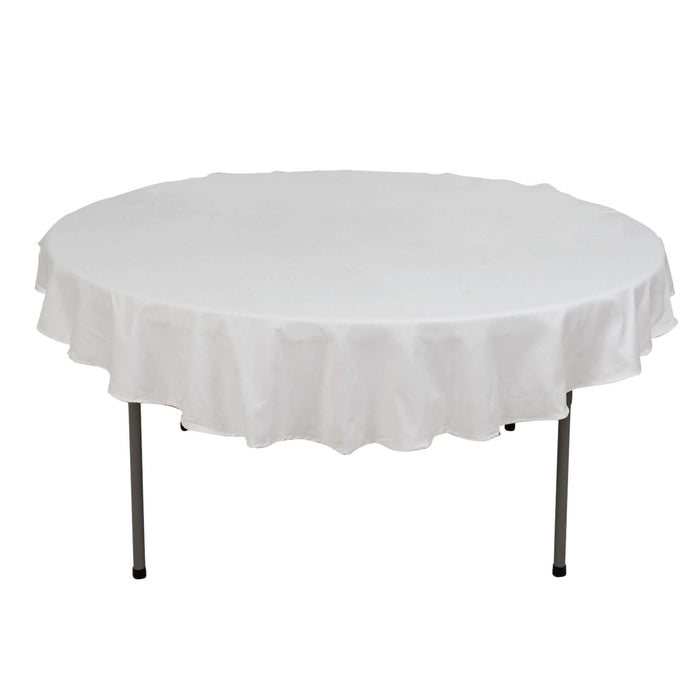 Round table with a white tablecloth, ideal for events and gatherings.
