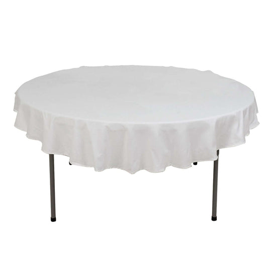 Round table with a white tablecloth, ideal for events and gatherings.