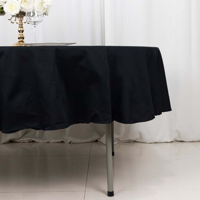 Black tablecloth draped over a table with elegant decor.
