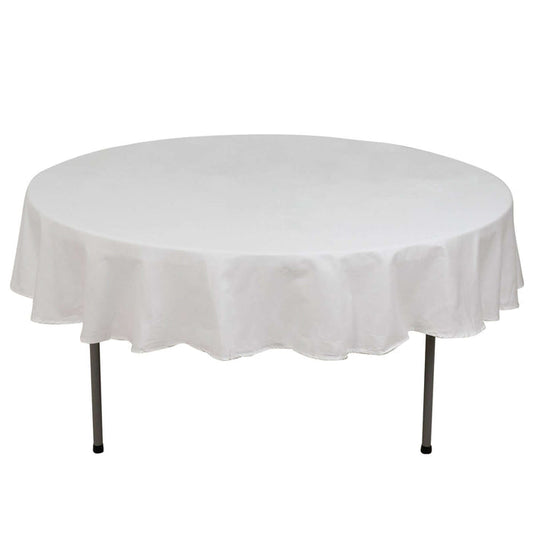 Round table with a white tablecloth on a plain background