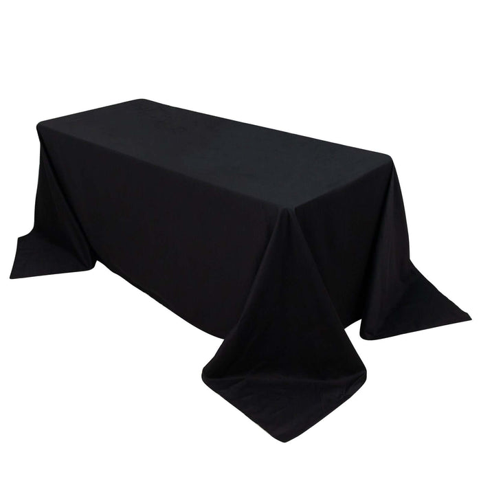 Black tablecloth draped over a rectangular table