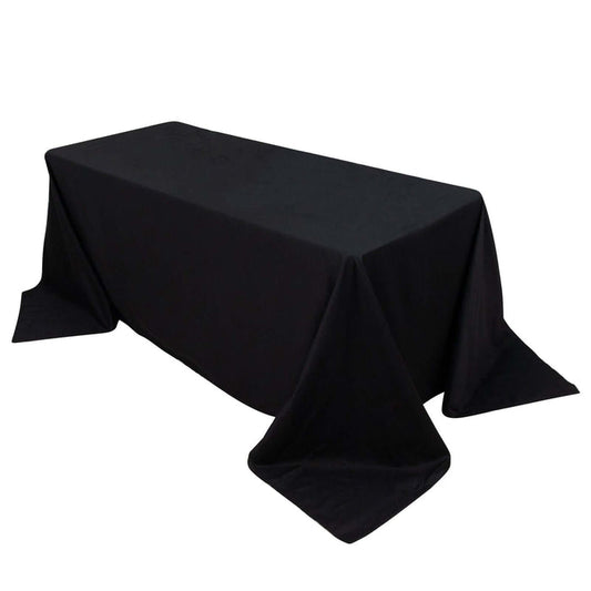 Black tablecloth draped over a rectangular table