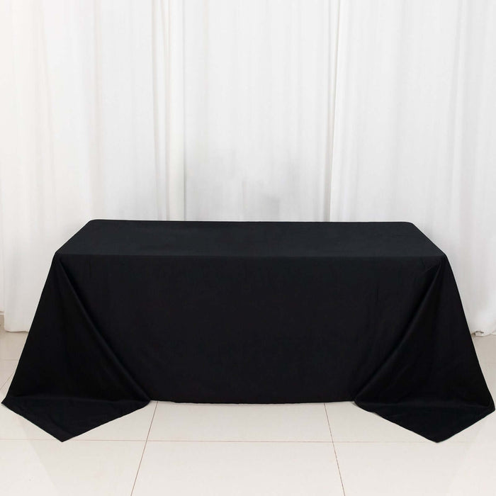 Black tablecloth draped over a table in a studio setting