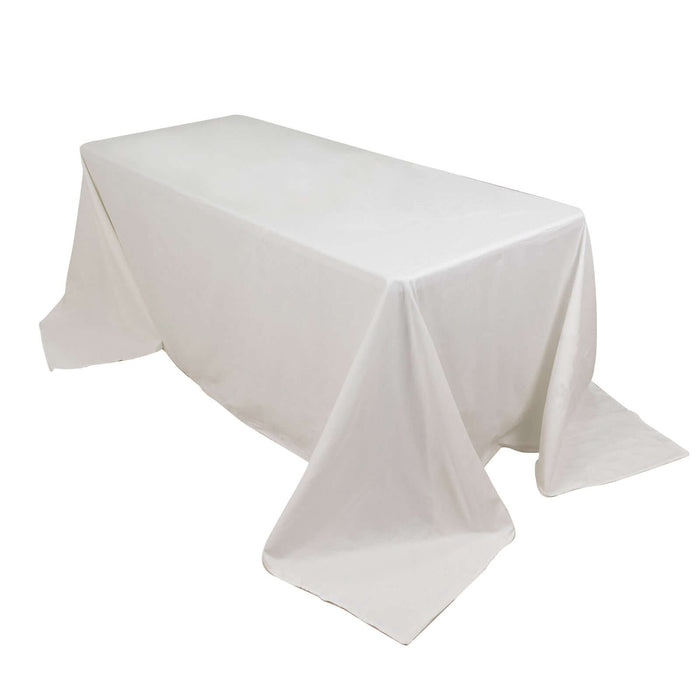 White rectangular table with a draped tablecloth