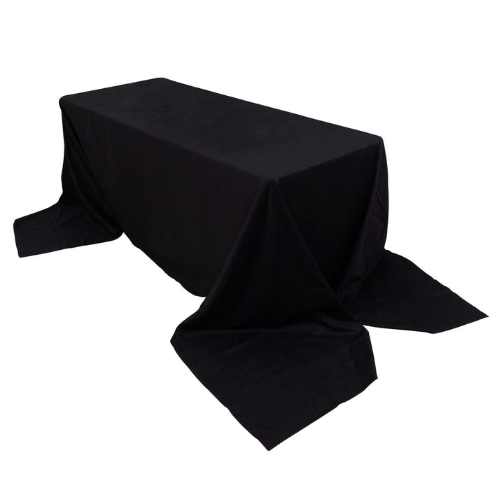 Black tablecloth draped over a rectangular table.