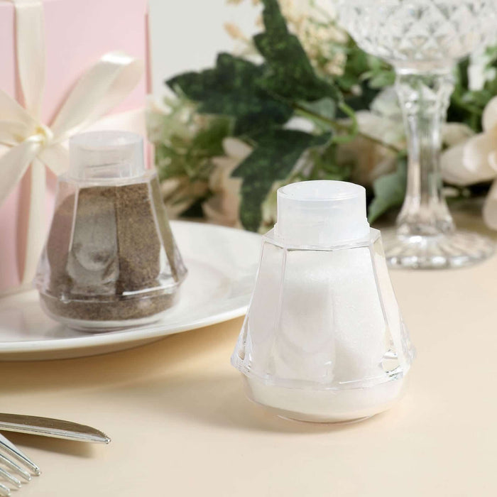 Clear salt and pepper shakers on a table with decorative elements.