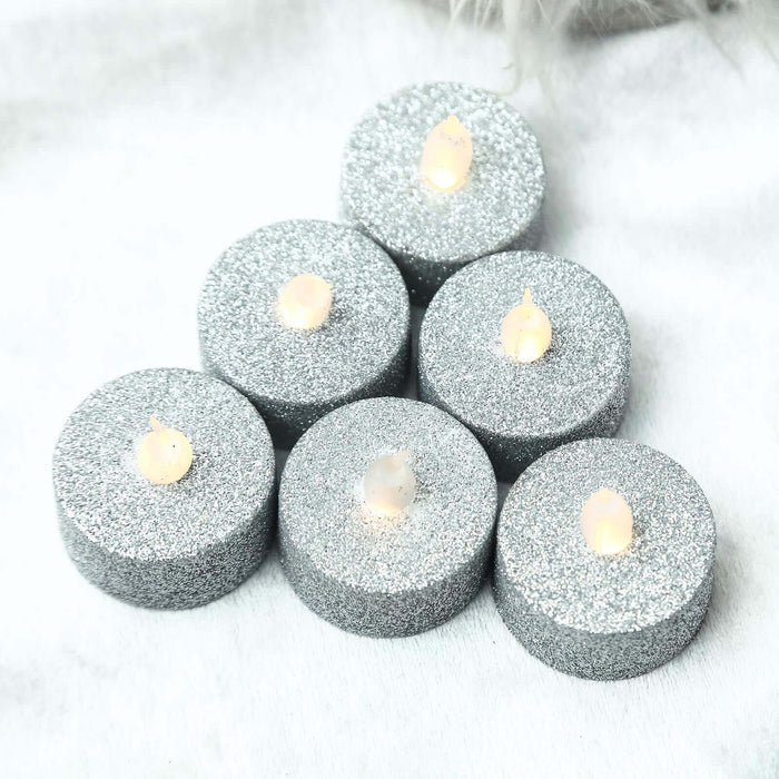 Glittery silver tealight candles with flickering flames