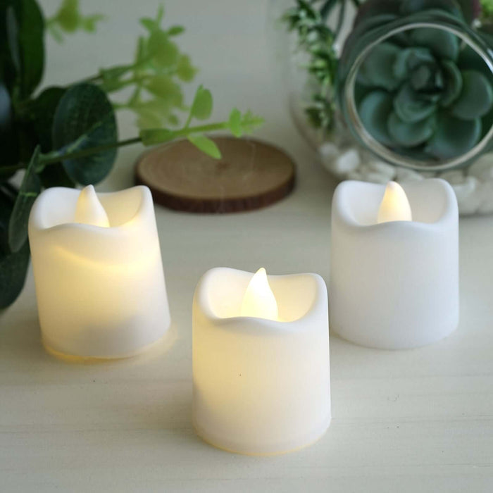 LED flameless candles in a soft white finish, glowing gently.