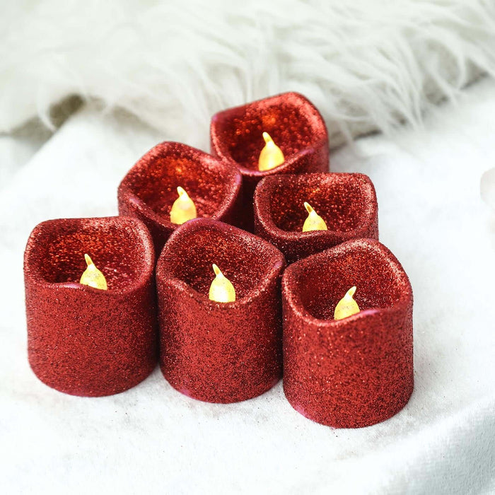 Red glitter LED tealight candles in a decorative arrangement.