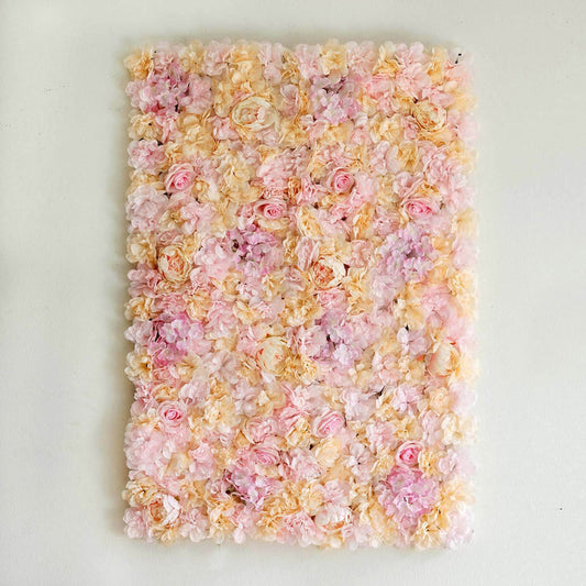 Artificial flower wall decor in pink and cream hues.