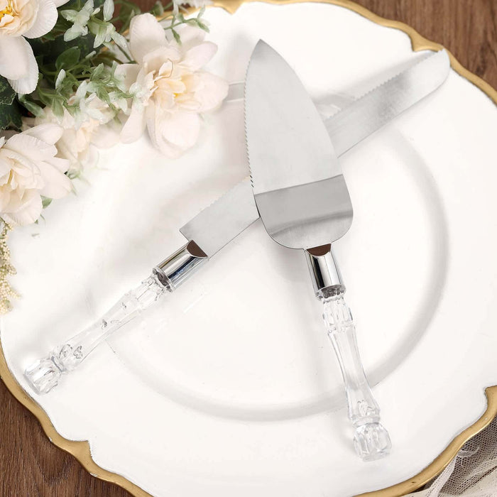 Decorative cake serving set with clear handles on a vintage plate.