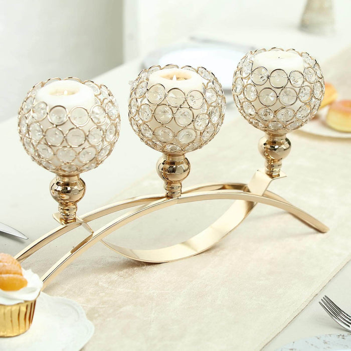 Elegant three-candle holder with crystal globes and gold accents.