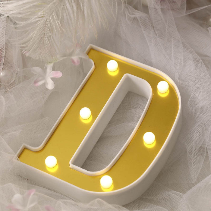 Decorative illuminated letter "D" in yellow and white.