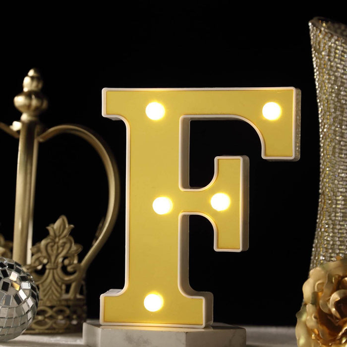 Yellow illuminated letter "F" decorative light with a stylish background. #whtbkgd