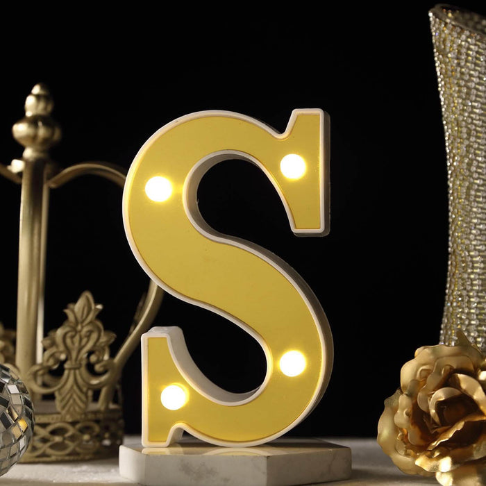 Yellow marquee letter "S" with lights on a decorative table setting. #whtbkgd