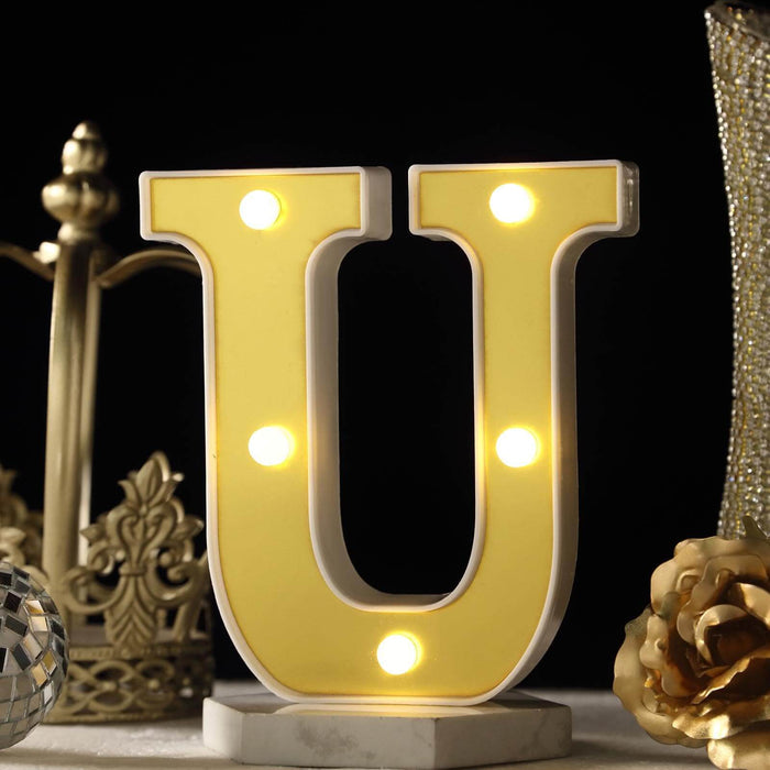 Yellow LED letter U marquee light on a dark background. #whtbkgd