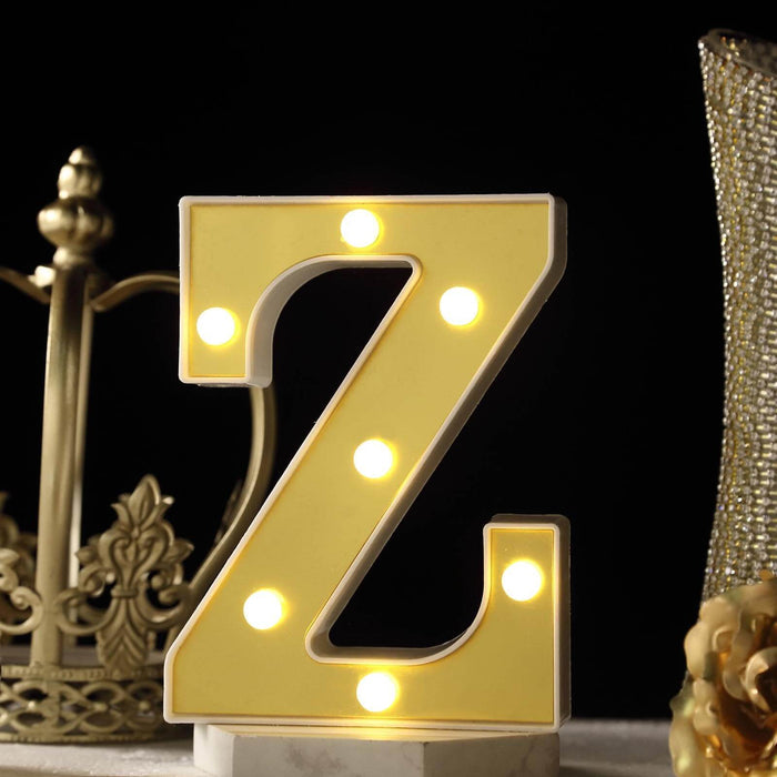 Yellow marquee letter "Z" with lights on a decorative table setting. #whtbkgd