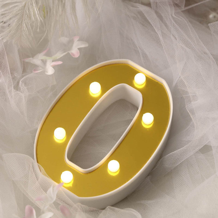 Decorative illuminated letter "O" with yellow and white design.