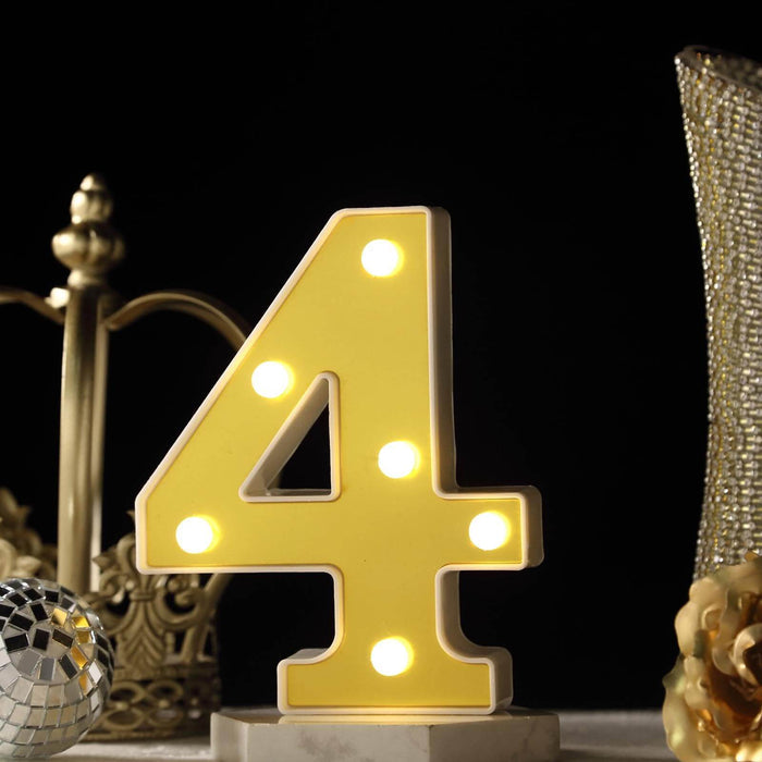 Yellow illuminated number 4 decorative light with bulbs. #whtbkgd