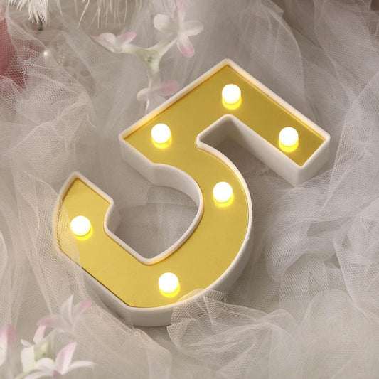 Illuminated number 5 decorative light with yellow and white design.