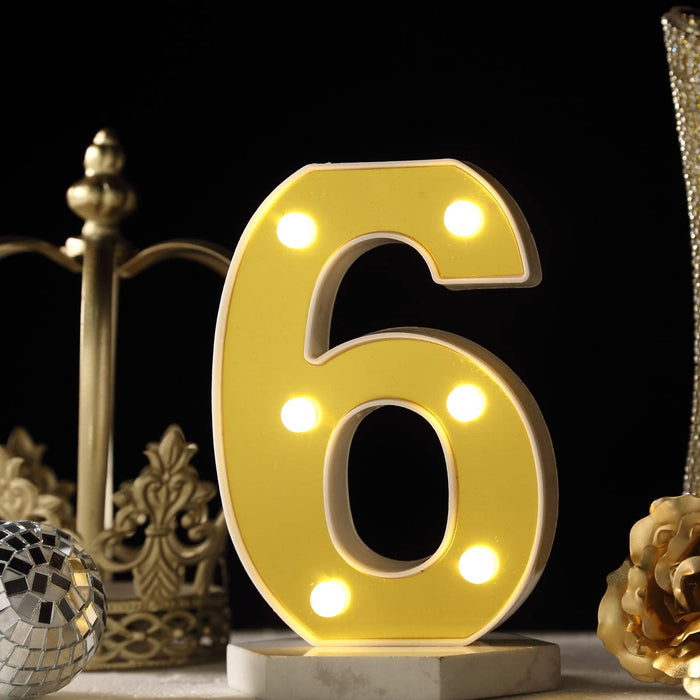 Decorative illuminated number 6 with yellow lights against a dark background. #whtbkgd