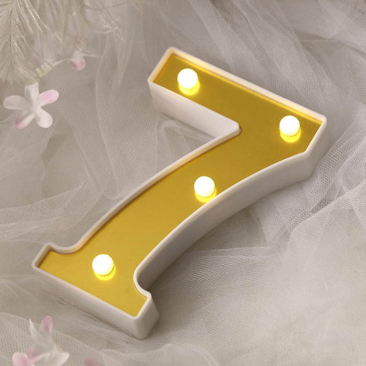 Yellow number 7 light-up sign with bulbs on a soft backdrop.