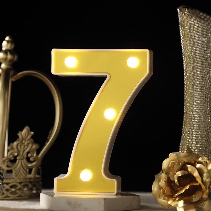 Yellow illuminated number 7 table decoration with lights. #whtbkgd