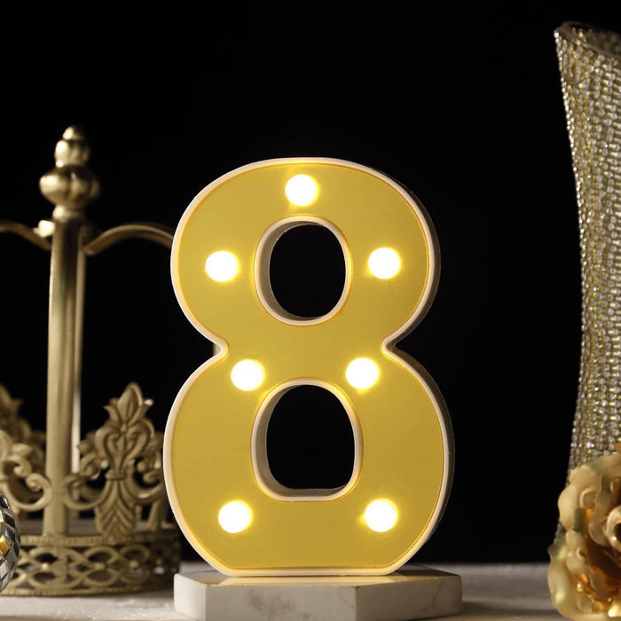 Yellow marquee number 8 with lights on a decorative backdrop. #whtbkgd
