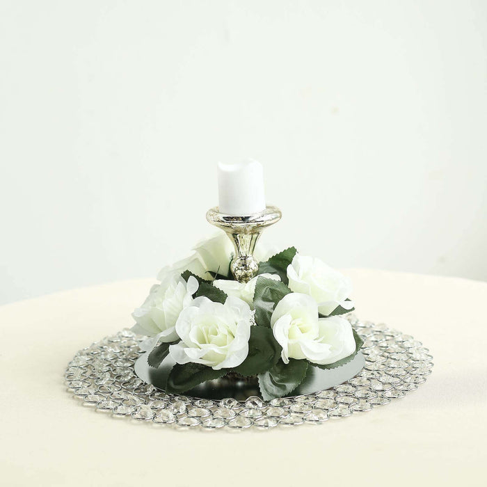 Decorative candle holder with white roses and a crystal base