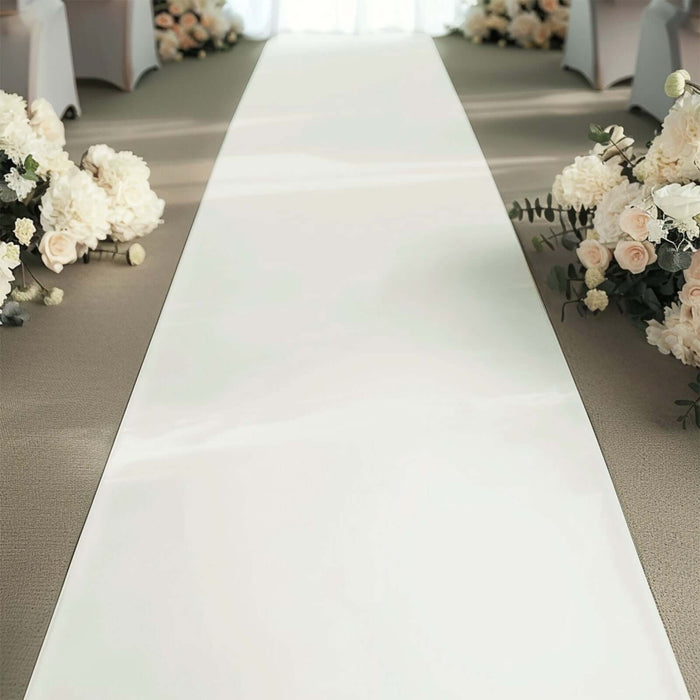 Wedding ceremony aisle with floral arrangements on both sides.