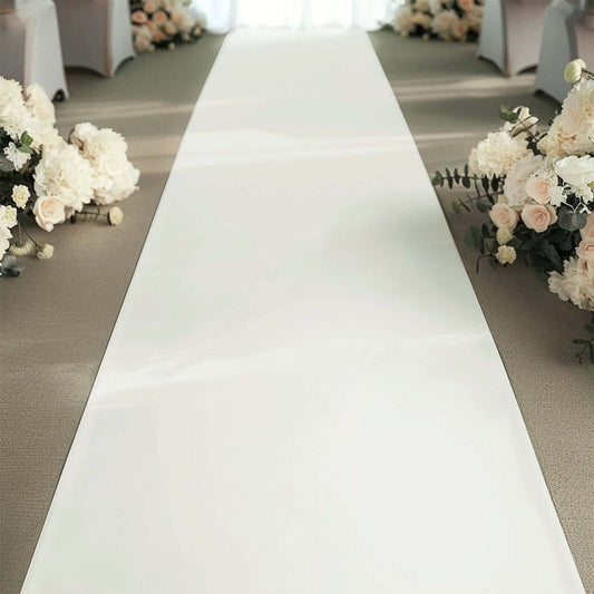 Wedding ceremony aisle with floral arrangements on both sides.
