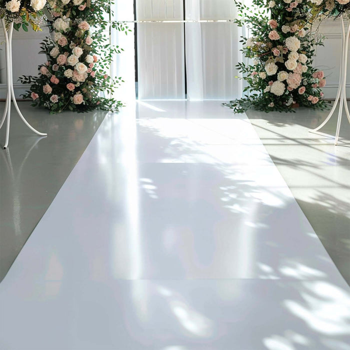Wedding aisle decorated with floral arrangements and soft lighting.