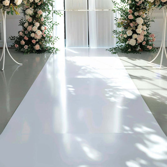 Wedding aisle decorated with floral arrangements and soft lighting.