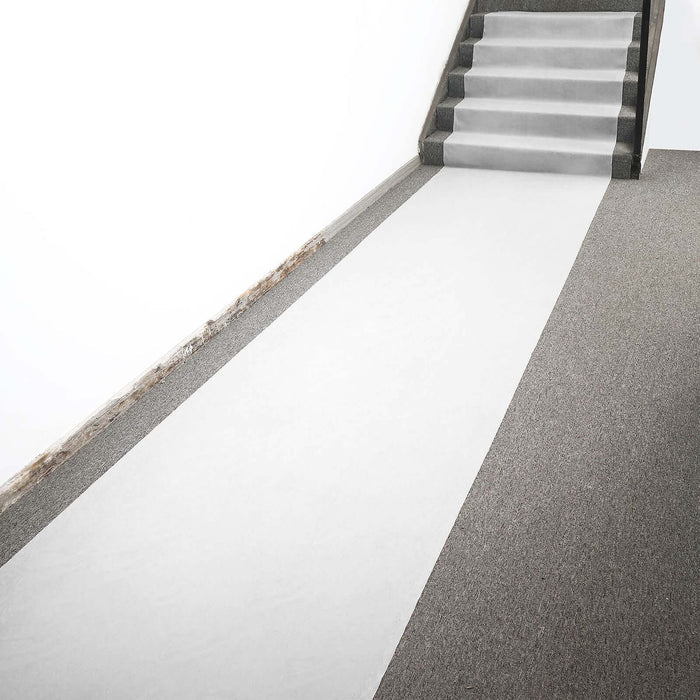 White carpet runner on staircase with gray flooring