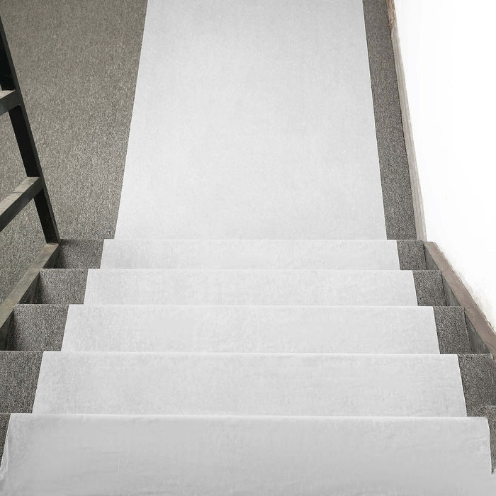 Staircase with gray carpet and white runner mat for safety and style