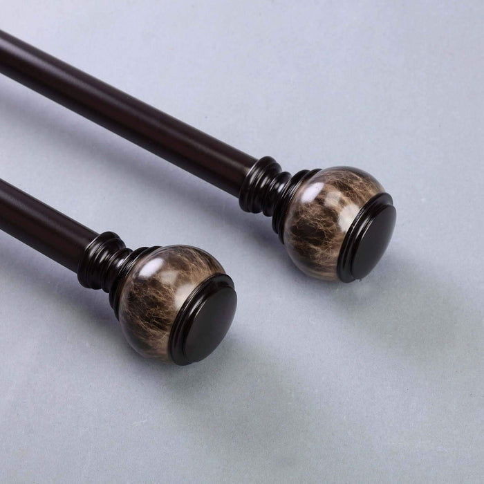 Decorative curtain rod with stylish finials in dark brown and marble design.