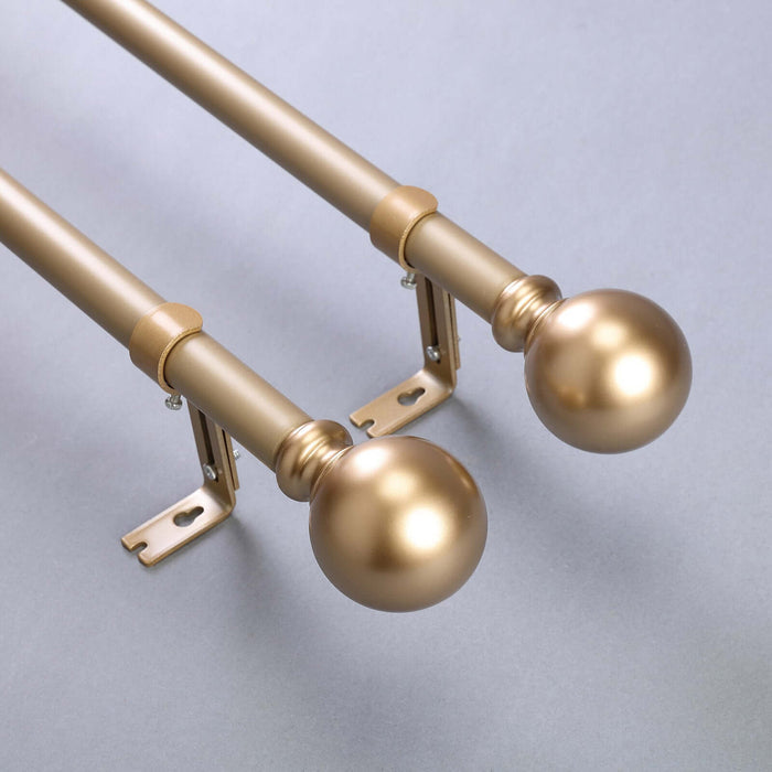 Gold curtain rod set with decorative finials