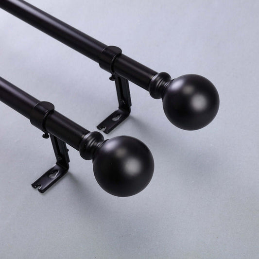 Black curtain rods with round finials and brackets.