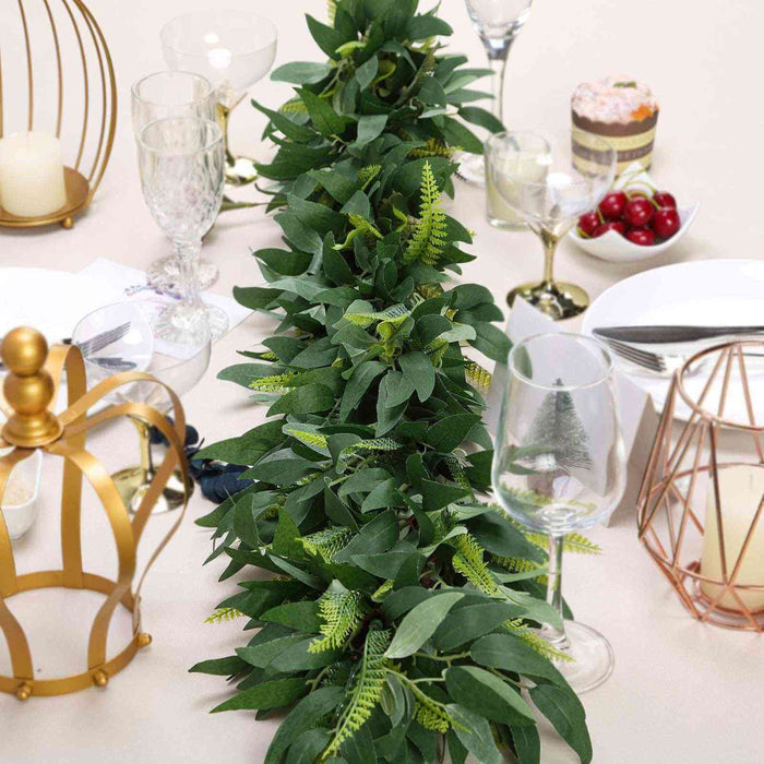 Artificial greenery table runner for festive decor.