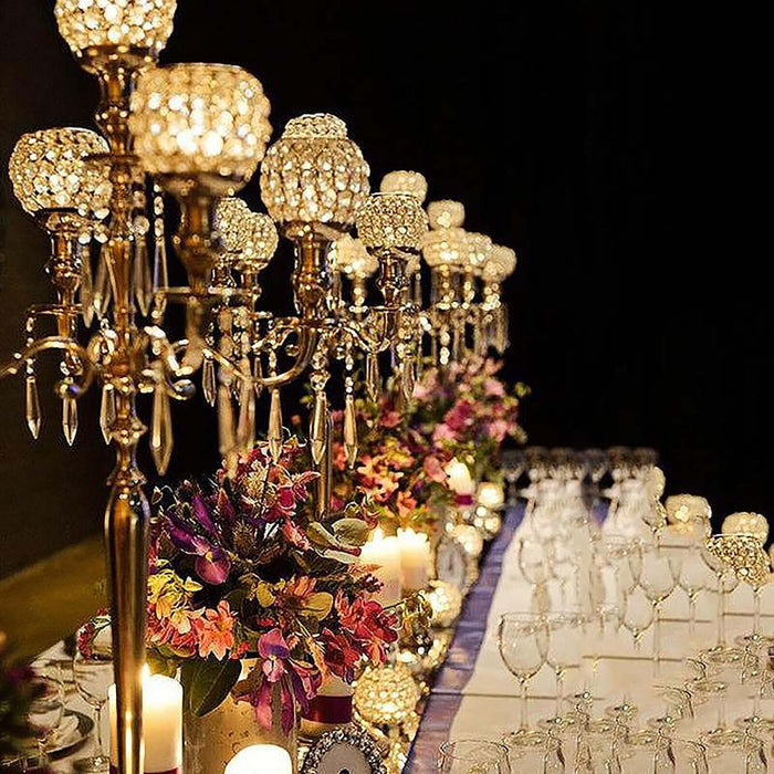 Elegant table setting with crystal candle holders and floral arrangements.